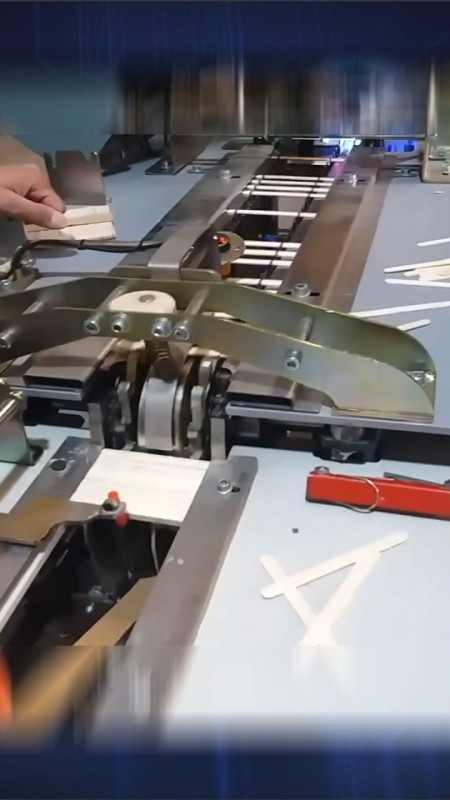 Intelligent packaging machine for ice cream stick and abselang based on machine vision